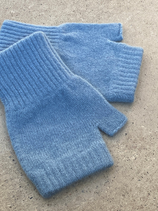 A pair of 100% lambswool fingerless mittens in Satin, a soft blue.
