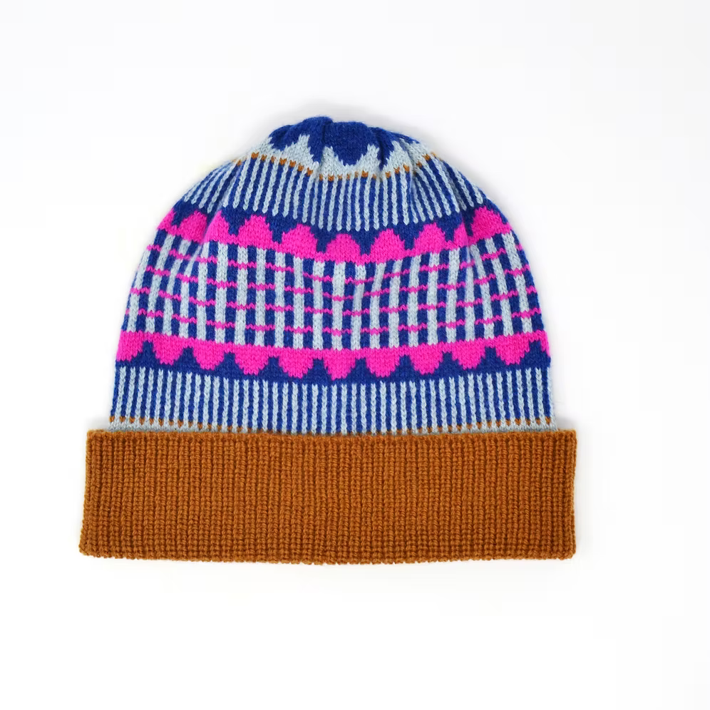 A Scarlet Knitwear brand 100% lambswool knitted hat with a brown rib and geometric design in shades of blue and bright pink.