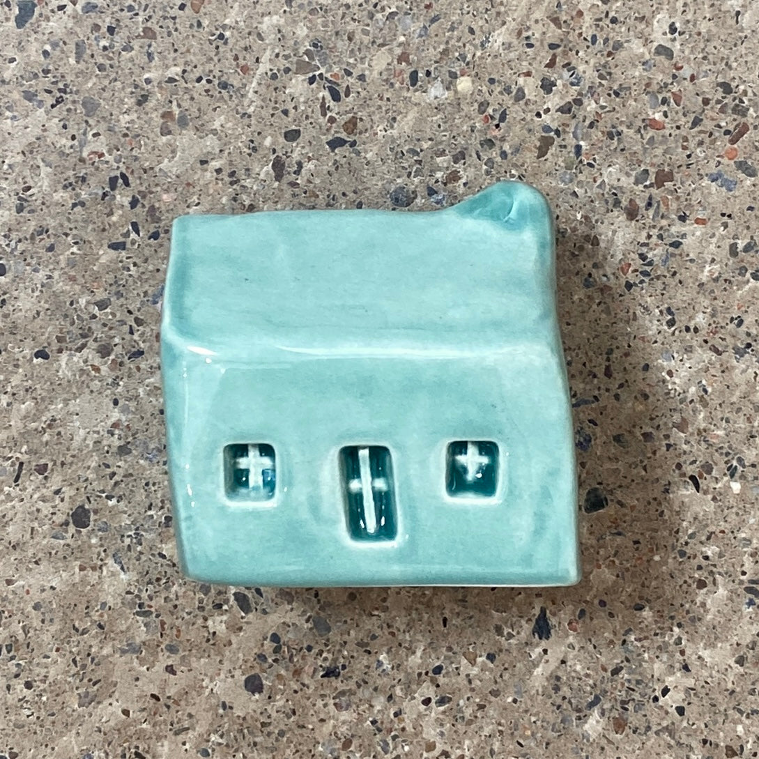 A handmade ceramic bothy with a bright Seamist blue glaze.