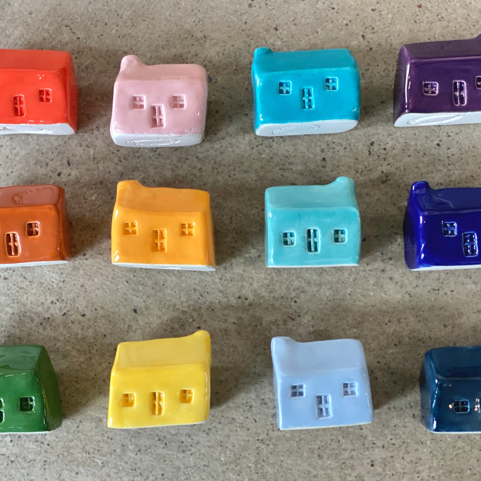 A rainbow of colourful handmade ceramic bothies.
