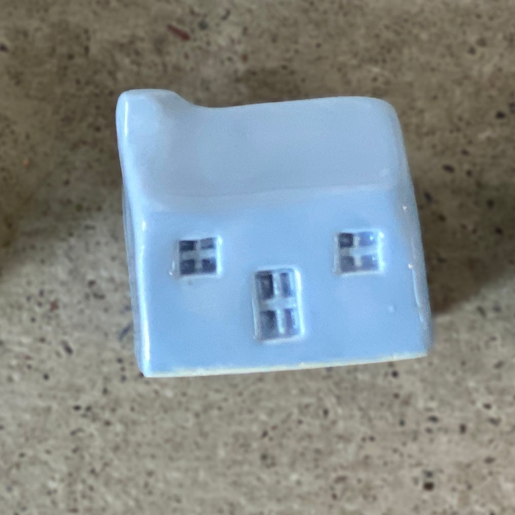 A handmade ceramic bothy with a light blue glaze.