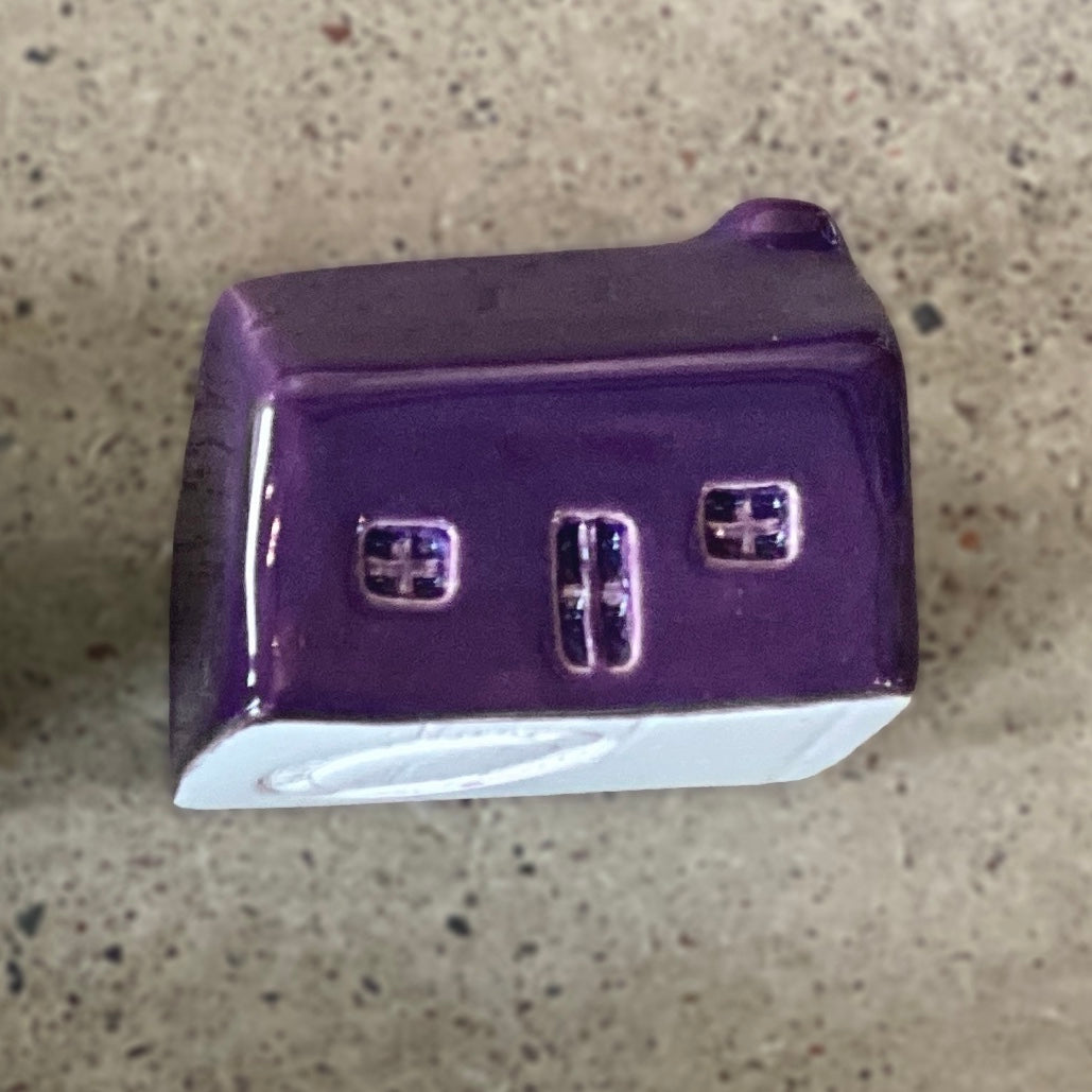 A handmade ceramic bothy with a bright purple glaze.