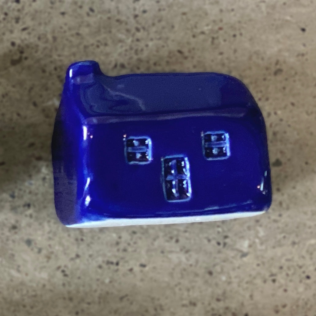 A handmade ceramic bothy with a bright blue glaze.