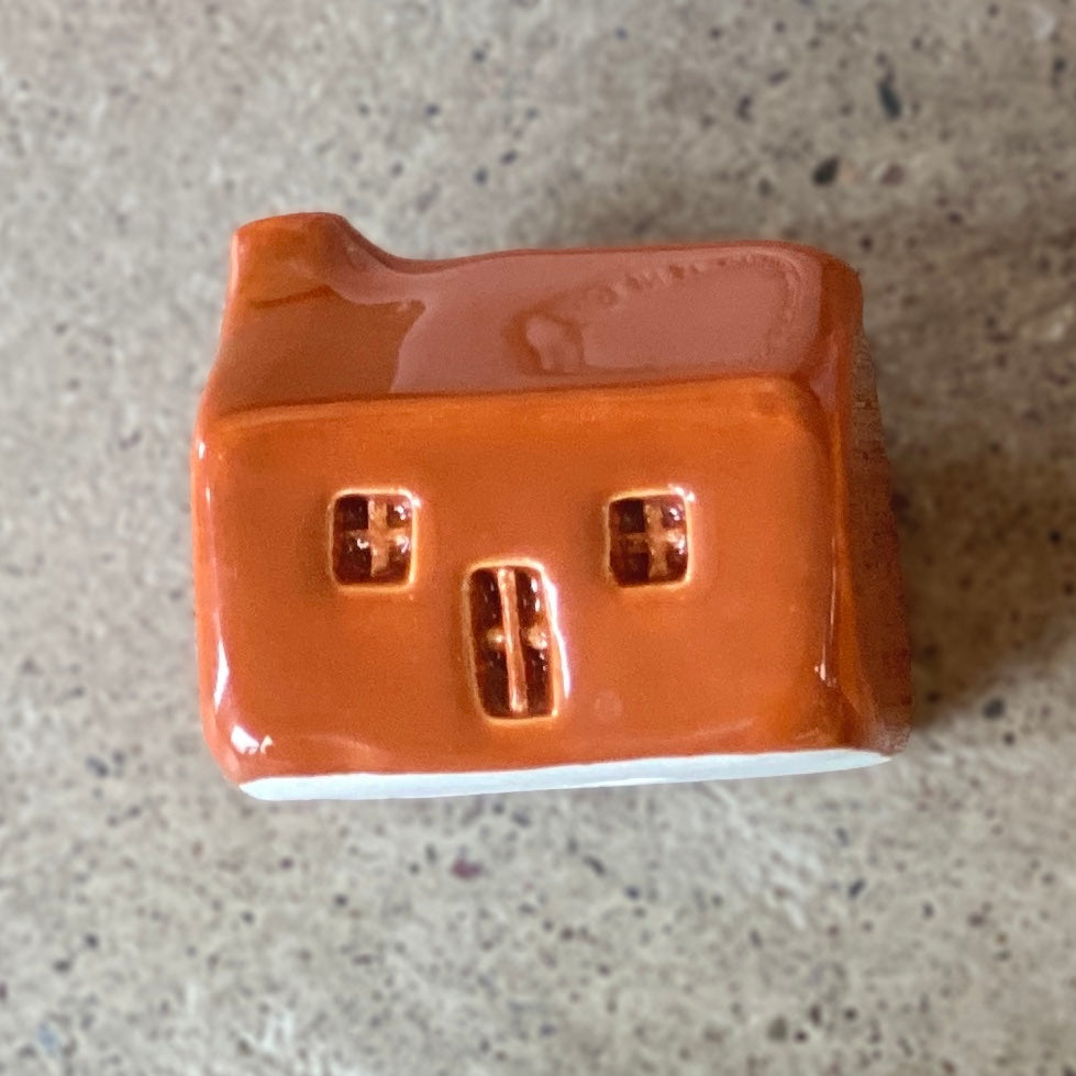 A handmade ceramic bothy with a Clay orange glaze.