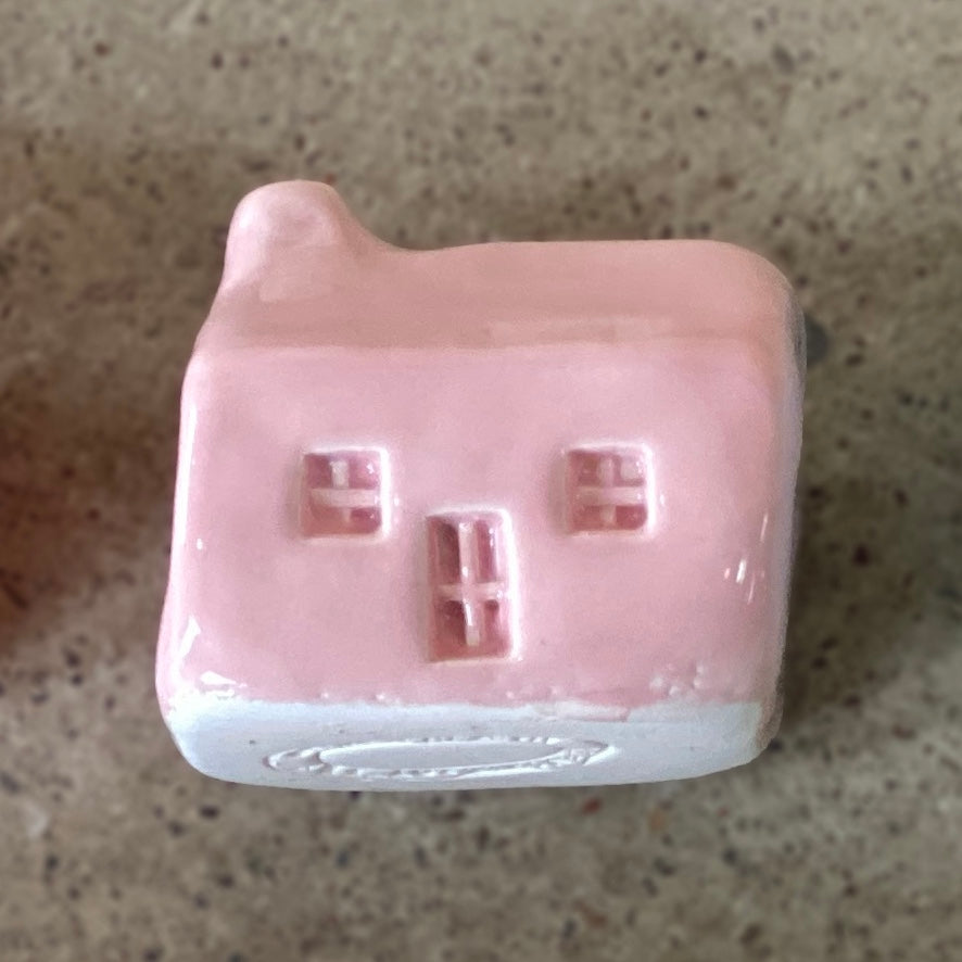 A handmade ceramic bothy with a light pink glaze.