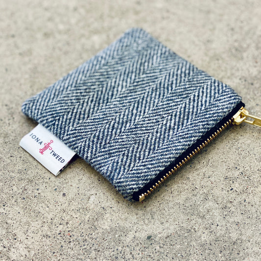 A small square coin purse made from single origin Iona Tweed with a brass zip and Iona Tweed certification side label.