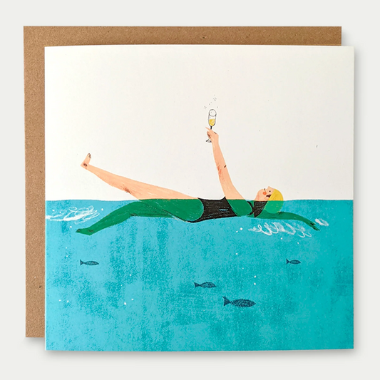 A square greeting card with kraft envelope, featuring a colourful swimmer illustration with blue sea.