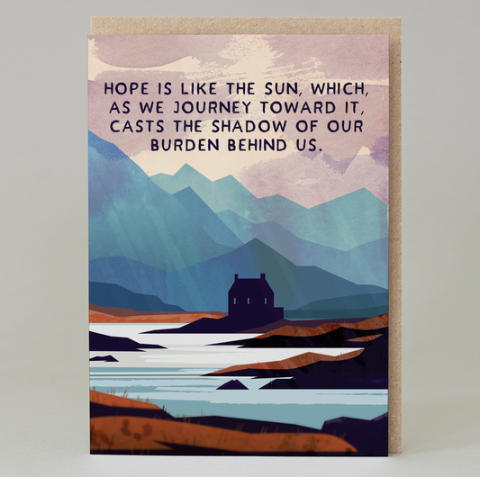 An A6 greeting card with 100% recycled brown envelope featuring a landscape illustration and the words 'Hope is Like the Sun, Which as we Journey Towards it, Casts the Shadow of our Burden Behind Us'.