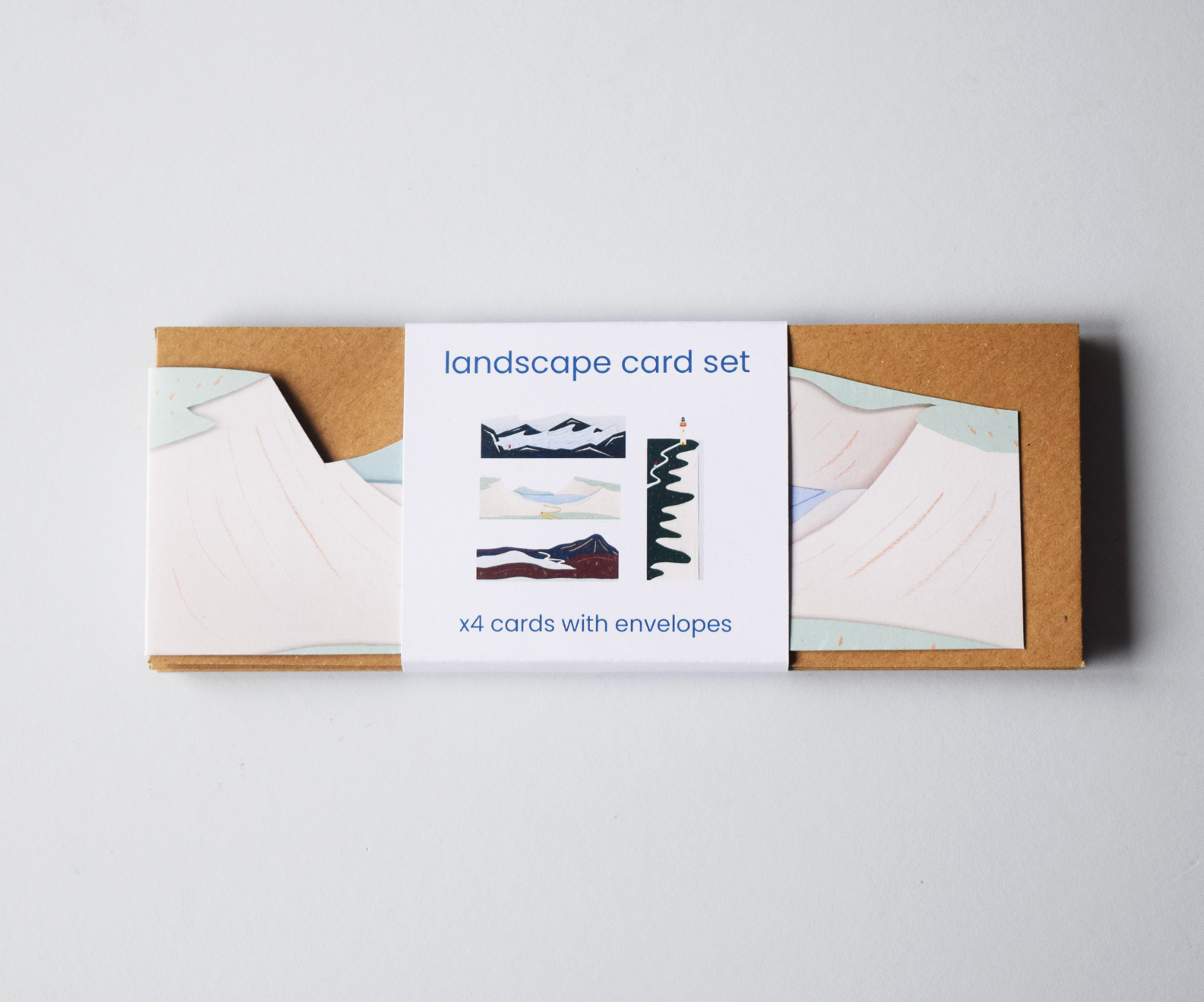 A packaged Landscape Card Set of 4 die-cut cards with kraft envelopes held together with a paper band.