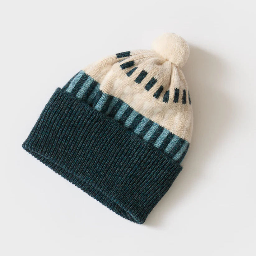 A 100% lambswool knitted pom hat in shades of blue and white.